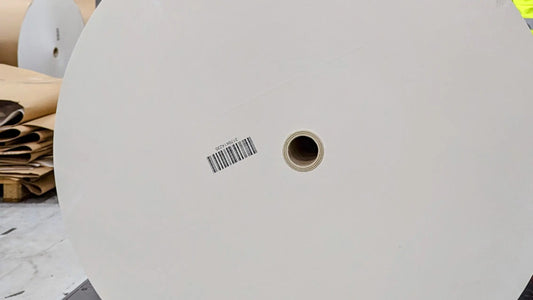The end-on view of a giant roll of paper ready to go onto a printing press to create a Collector's edition book