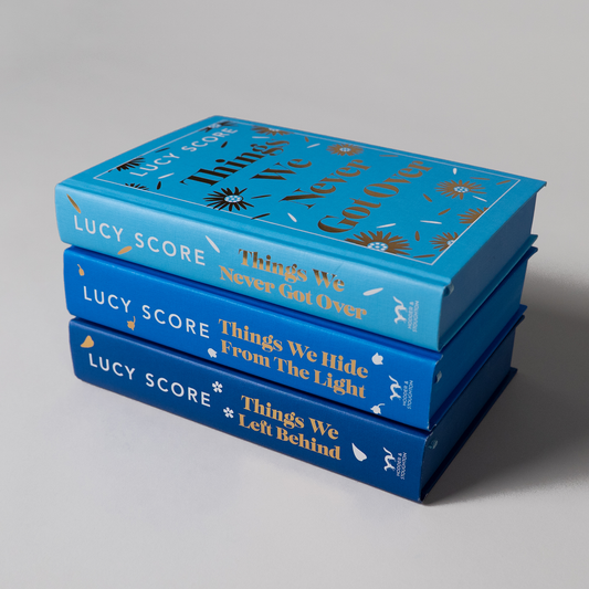All three books in Lucy Score's Knockemout series, in blue hardbacks with gold foil