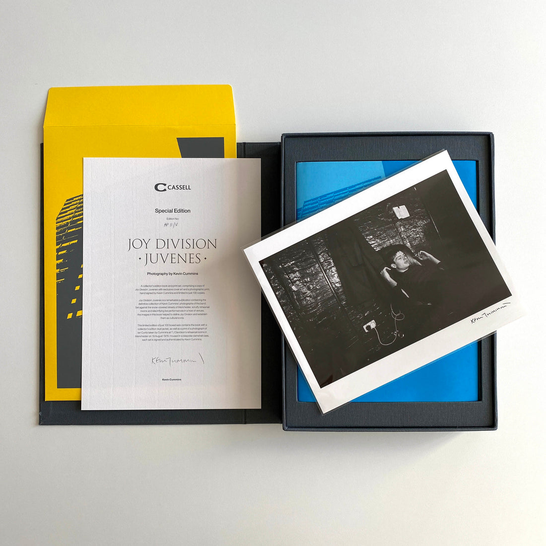 Kevin Cummins' Joy Division collectable photographic book is laid out in the clamshell case showing the signed black and white photo of Joy Division, certificate of authenticity and envelope